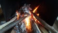 Fire on logs in fire pot with embers and burning coal and blazing flames Royalty Free Stock Photo