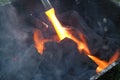 Fire on logs in fire pot with embers and burning coal and blazing flames Royalty Free Stock Photo