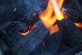 Fire on logs in fire pot with embers and burning coal and blazing flames Royalty Free Stock Photo