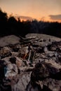 Fire making process in the wild at sunset. Building of campfire using dry branches in forest Royalty Free Stock Photo