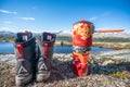 Fire maple Outdoor cookery with propane gas boiler next to Alfa hiking boots with mountain scenery view.