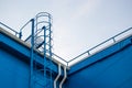 Fire metal staircase on a building metal wall against a blue sky Royalty Free Stock Photo