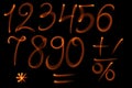 The fire numbers set collection alphabet on black background Royalty Free Stock Photo