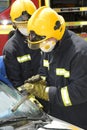 Fire officer cutting away a windscreen at car smash Royalty Free Stock Photo