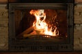 Fire in an old cast iron fireplace. Fire in the form of a human face Royalty Free Stock Photo