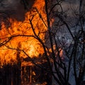 Fire in the old wooden house. Burning house. Fully involved. Photo of huge flame distracting house on fire. Fire safety Royalty Free Stock Photo