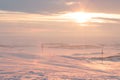 Fire orange and red with yellow colors of sunset evening sky with clouds and mountains on horizon background, picturesque Royalty Free Stock Photo