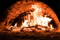 Fire in the oven. Dark background. Concepts of cooking on a fire in the oven. Pizza in the coals. Royalty Free Stock Photo