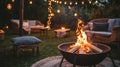 Fire pit with glowing flames and string lights Royalty Free Stock Photo