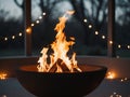 Fire pit with glowing flames and string lights. Royalty Free Stock Photo