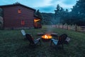 Fire pit. Outdoor fire pit with red flame. Cozy Log cabin home in Mountain North Carolina. Evening gatherings by the fire Royalty Free Stock Photo