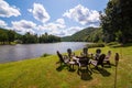 A fire pit surrounded by adirondack chairs next to the Allegheny river in Warren county, Pennsylvania, USA