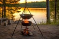 fire pit with tripod holding a kettle for boiling water Royalty Free Stock Photo