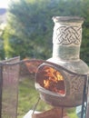 Fire placa, pot, chemney at evening in the garden Royalty Free Stock Photo