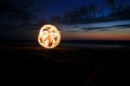 Fire poi on beach in sunset Royalty Free Stock Photo