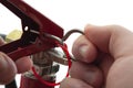 Fire prevention equipment concept with closeup on firefighter hand pulling the pin on a red fire extinguisher isolated on white Royalty Free Stock Photo