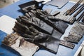 Fire Protection gloves, pliers and many pieces of steel on the desk to be used in electric metal welding workshop.