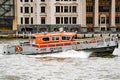 A Fire and Rescue boat on its way along the Thames with its Blue lights flashing and its sirens really loud Royalty Free Stock Photo