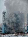 Fire in a residential high-rise building. Lots of smoke and fire trucks Royalty Free Stock Photo