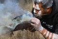 The fire ritual rite at an indigenous community event in Australia, a man starts a fire from eucalyptus branches