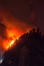 The fire on a roof of the high-rise building in the big city Royalty Free Stock Photo