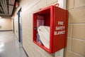 A fire safety blanket in its red container on a wall Royalty Free Stock Photo
