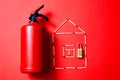 Fire safety, or security and protection concept. A fire extinguisher, the figure of the house and lock Royalty Free Stock Photo