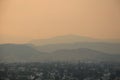 Fire season Kelowna- Sunset with smoky sky- 4 layers of mountains showing