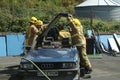 Firemen practice cutting an injured driver out of a wrecked car