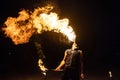 Fire show artist breathe fire in the dark