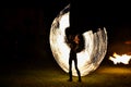 Fire show - artists jumping over a burning skipping rope in the dark