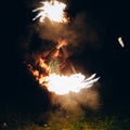 Fire Show at night. Man stands in front of an Royalty Free Stock Photo