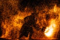 Fire show at night. Young men stands in front of Royalty Free Stock Photo