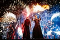 Fire show at night. Young men stands in front of Royalty Free Stock Photo