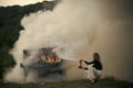 Fire and smoke on grunge instrument. fire and white smoke at burning piano and girl firefighter.