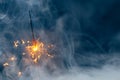 Fire sparkler in dense smoke, abstract Christmas firework background Royalty Free Stock Photo