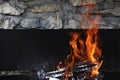 Fire sparks particles with flame isolated on black and stone background Royalty Free Stock Photo