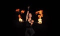 Fire and sparks. Sexy woman twirl burning stick in darkness. Fire performance. Baton twirling. Juggling devil stick