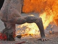 Fire spitting man in headstand