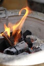 Fire starter with a flame on a charcoal stove Royalty Free Stock Photo