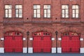 Fire station, an old historic brick building 1880s with red gates. Fire department