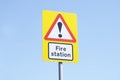 Fire station sign blue background sky yellow red white direction emergency services brigade serviceman uk