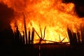 Fire storm raging and destroying an empty wooden structure