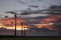 Fire sunset over wind turbines Royalty Free Stock Photo