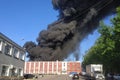 Fire - Thick acrid black smoke pours from the roof of the house. Royalty Free Stock Photo