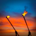 Fire torch at sunset sky with red clouds Royalty Free Stock Photo