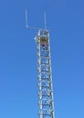 A fire tower antenna in a blue sky