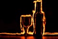 The fire traces around the glass and wine bottle Royalty Free Stock Photo