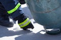 Fire trainer, pouring liquid LPG gas into bottle by upside down