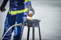 Fire trainer teach pouring oil into pan flames for conflagration